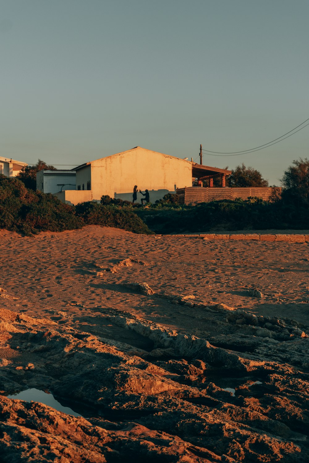 a man riding a surfboard on top of a sandy beach