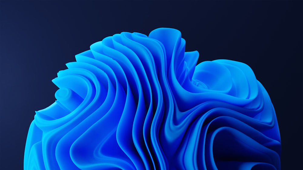a blue object with wavy shapes on a black background