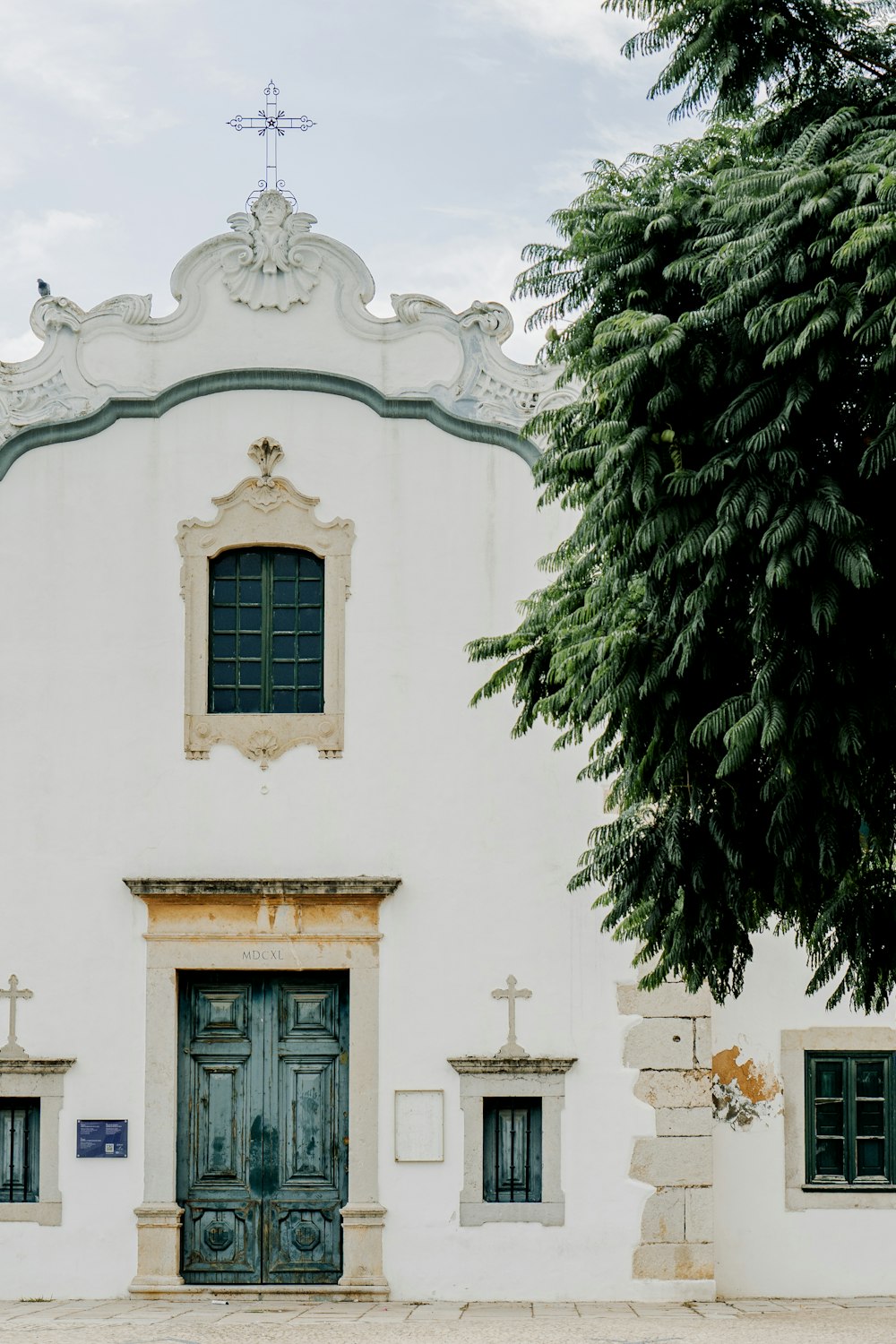 a large white building with a green door