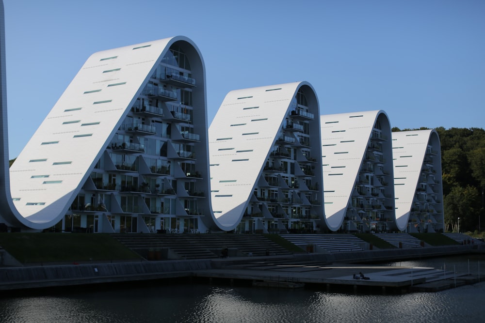 a row of buildings sitting next to a body of water