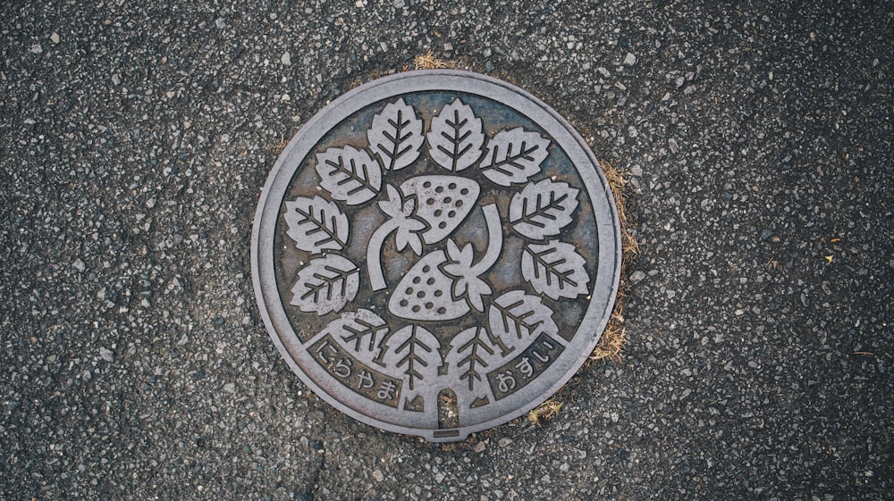 a manhole cover with a tree design on it