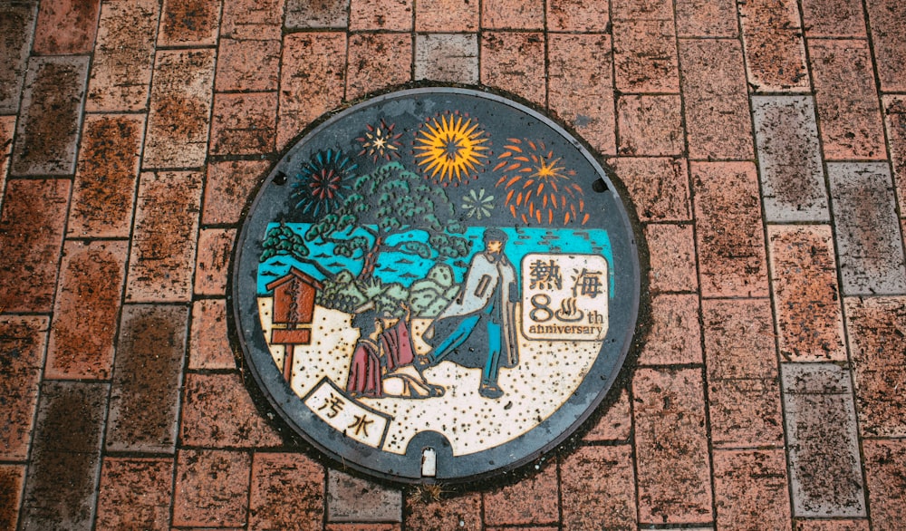 a picture of a manhole cover on a brick wall