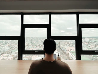 Female attorney reviewing legal documents at a sleek desk with a city view.