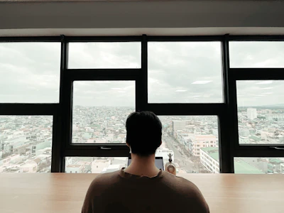 A consultant reviewing environmental policy documents with a cityscape in the background.