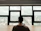 Photo of a professional man reviewing documents at a desk with a window view of the Willamette Valley.