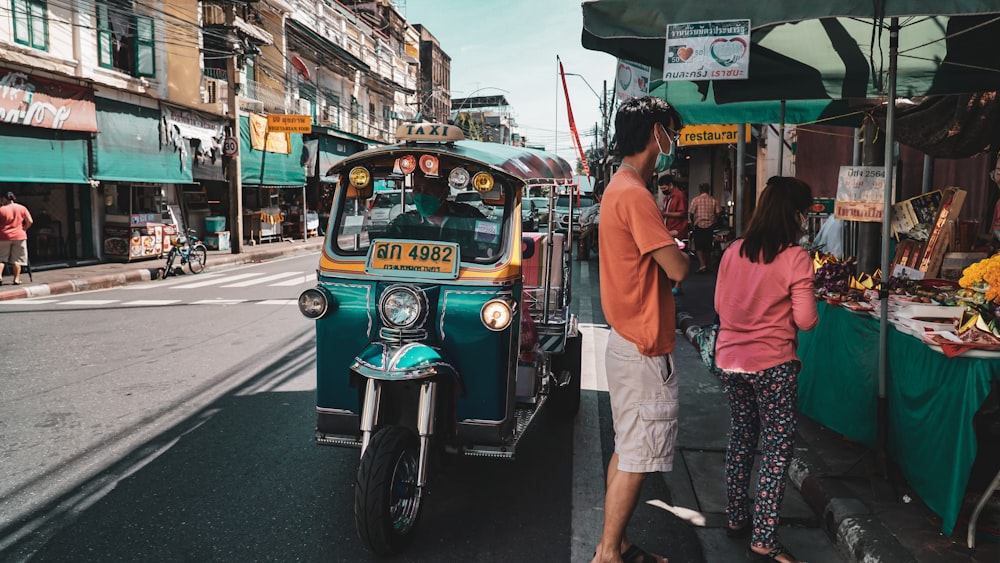 a man and a woman standing next to a food truck