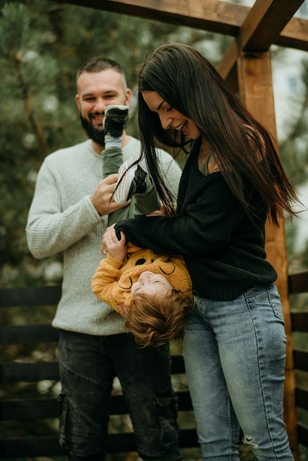 a man taking a picture of a woman holding a child