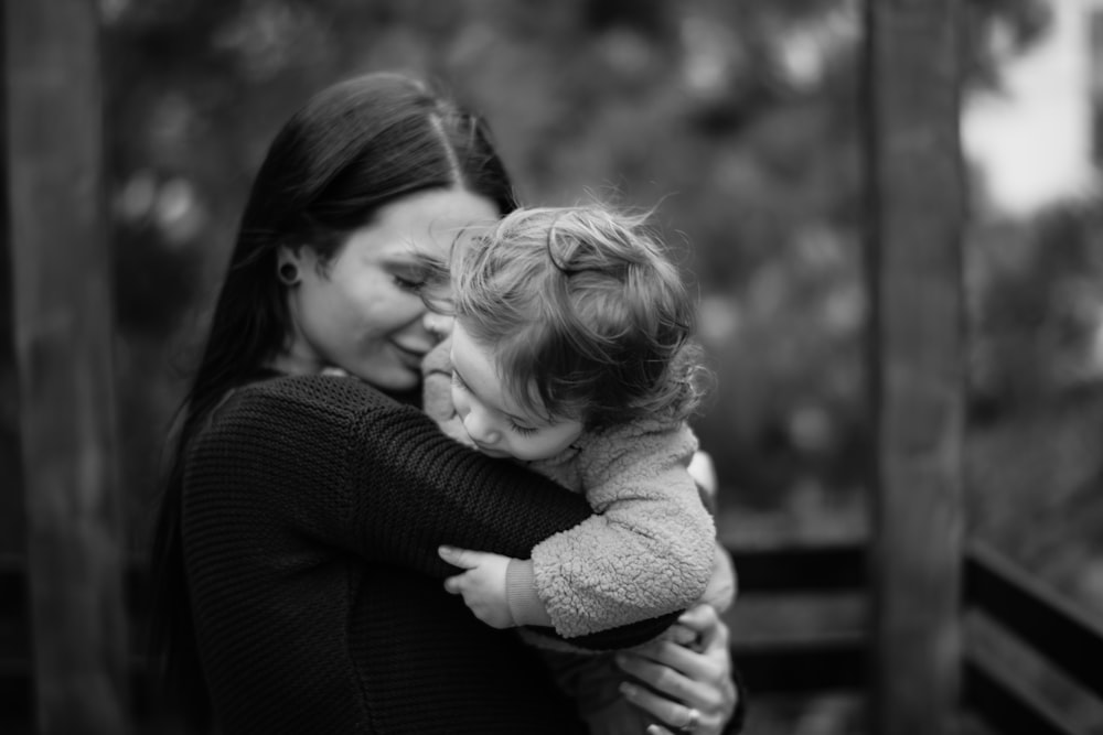 a woman holding a small child in her arms