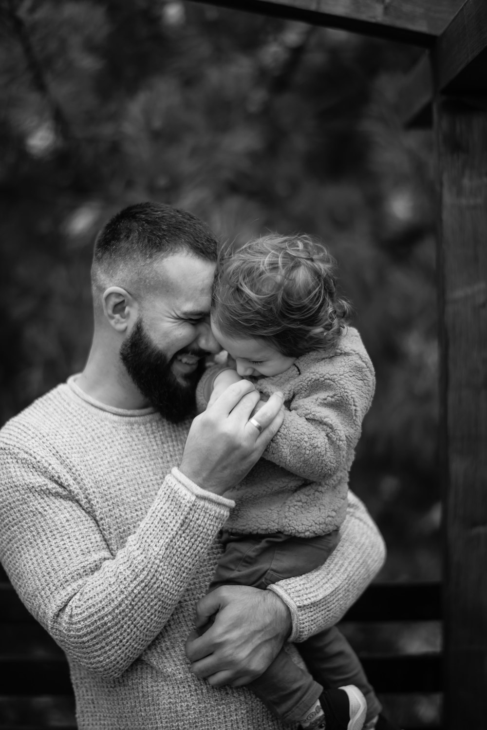 a man holding a little girl in his arms