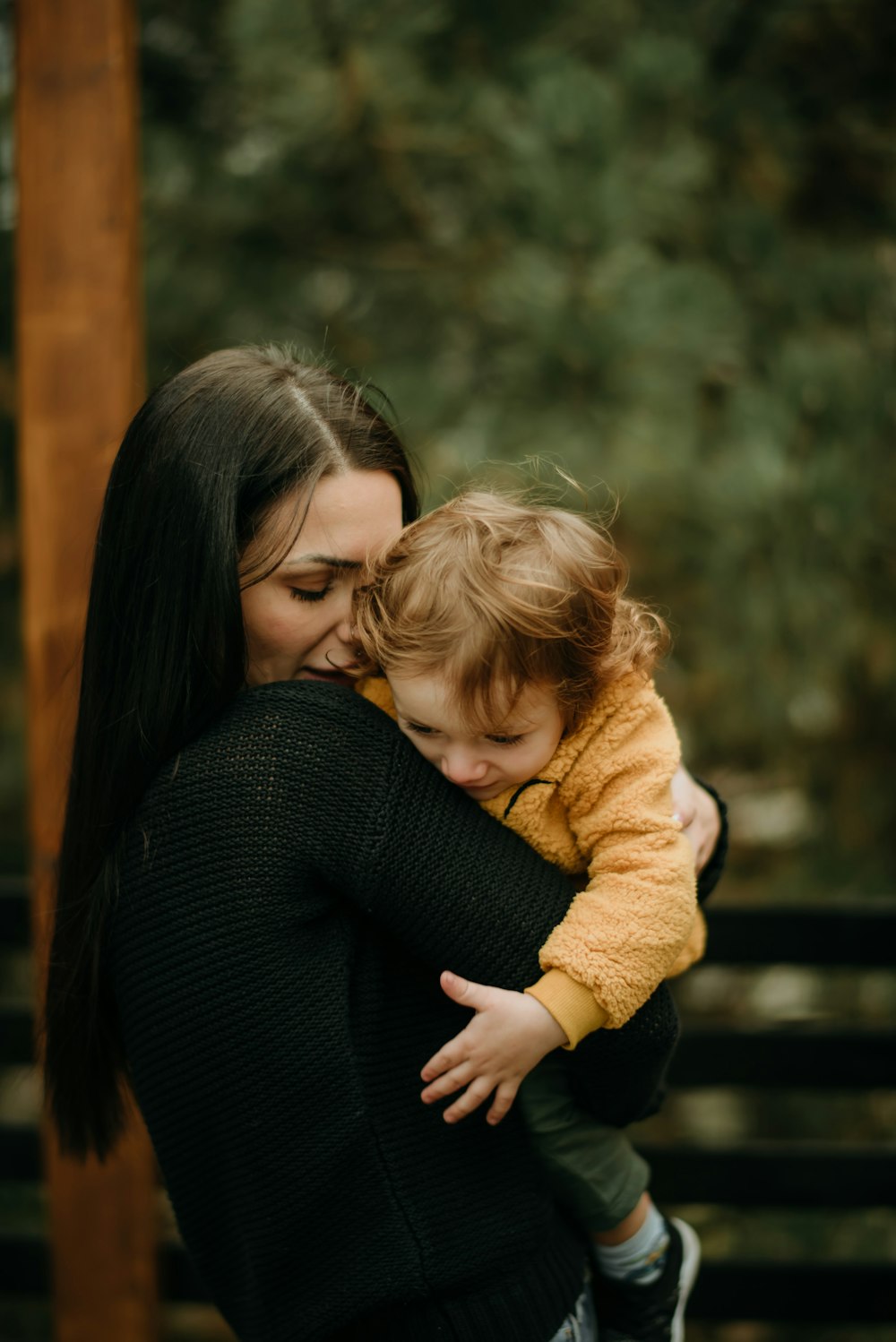 a woman holding a small child in her arms