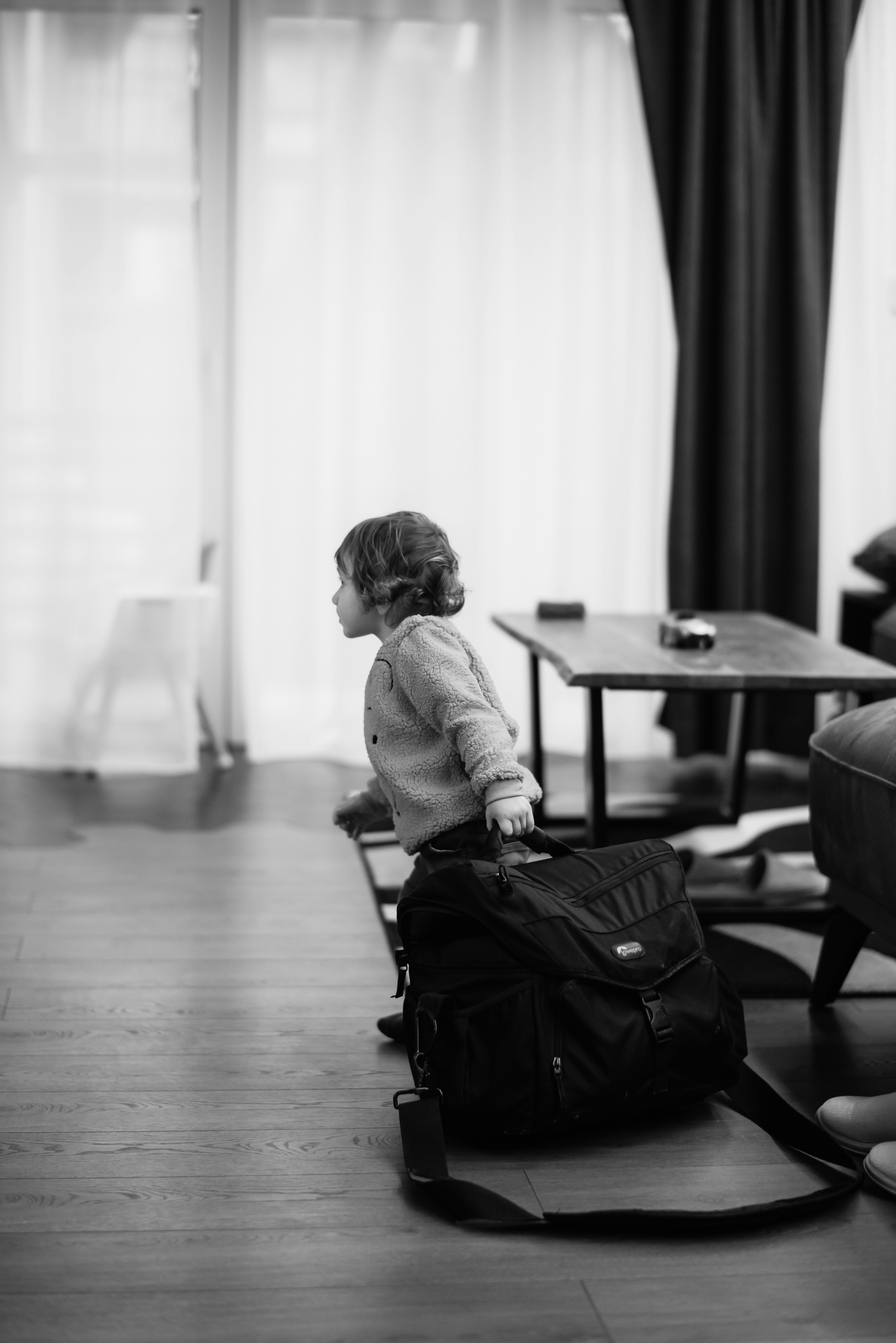 a small child sitting on top of a piece of luggage