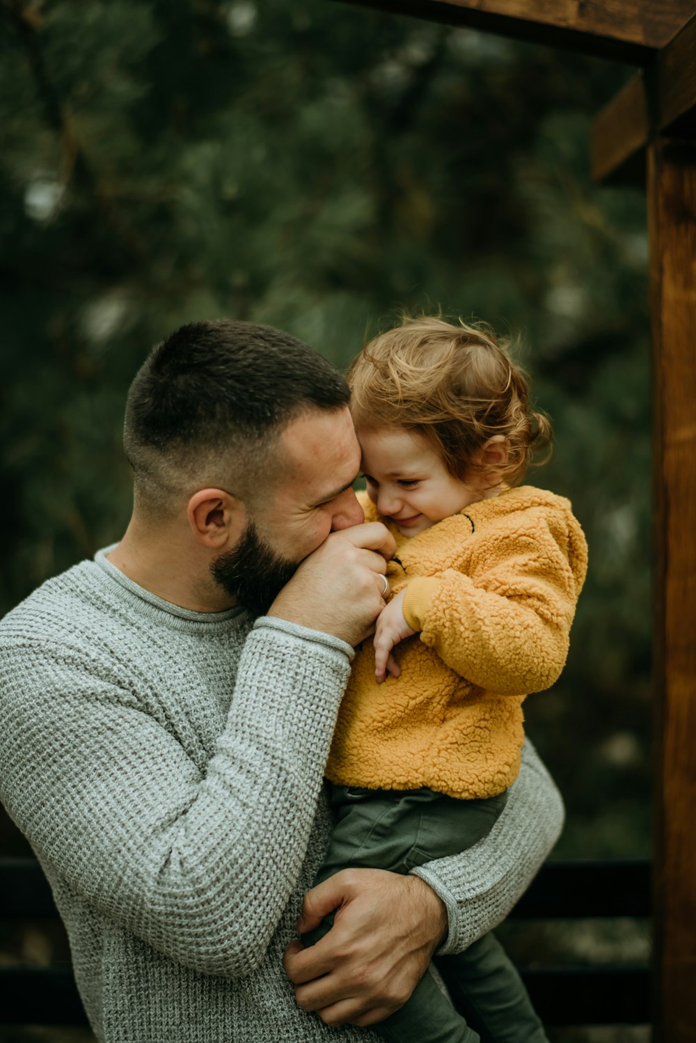 a man holding a little girl in his arms