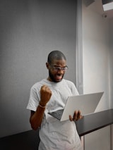 A person excitedly pointing at a computer screen showing the xyz domain purchase confirmation.