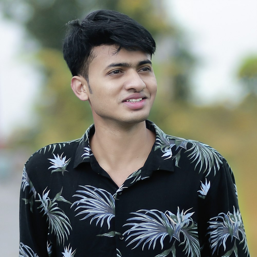 a man in a black shirt with a flowered shirt on