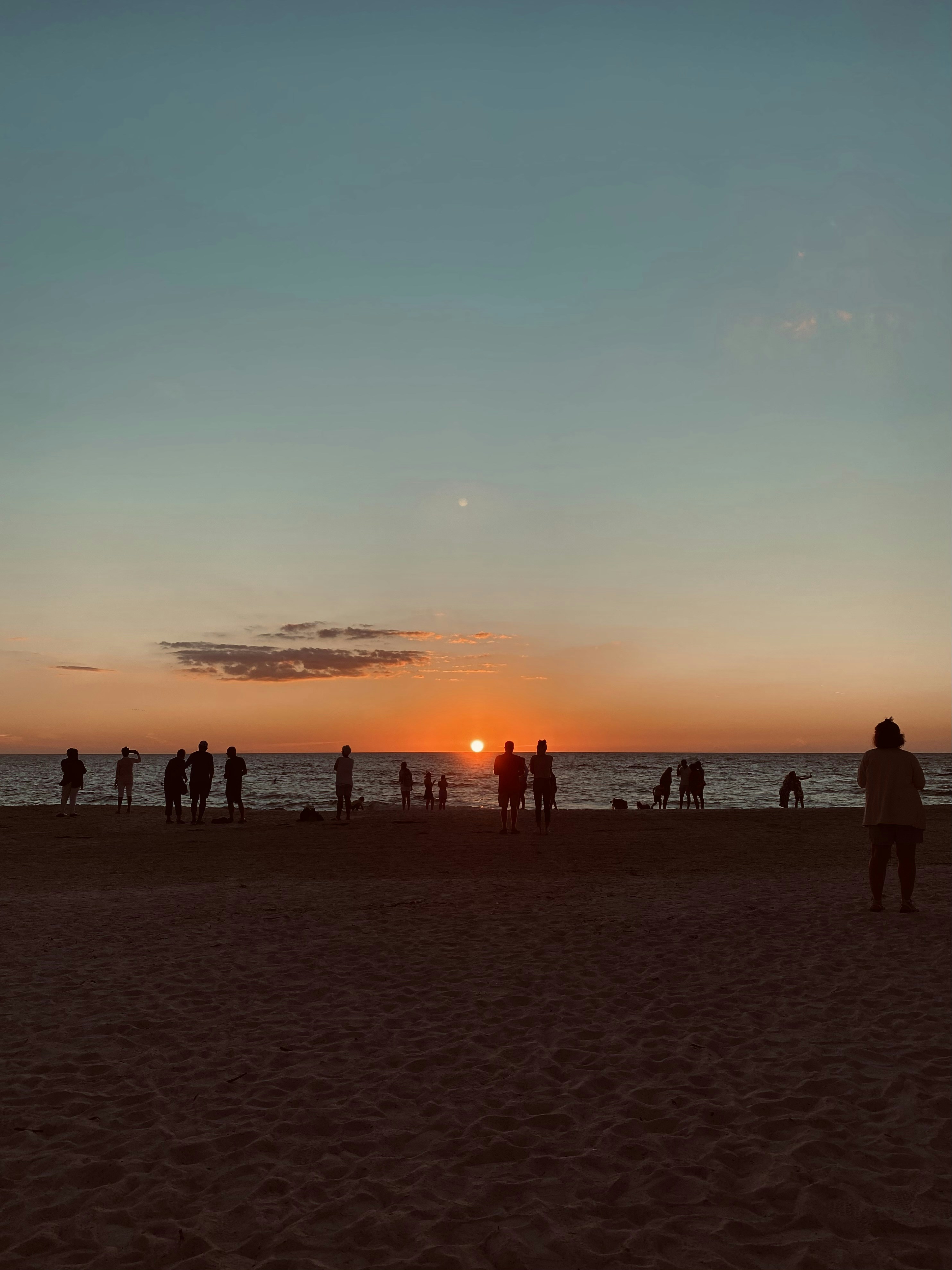 People enjoying the sunset at Baldwin Beach Park