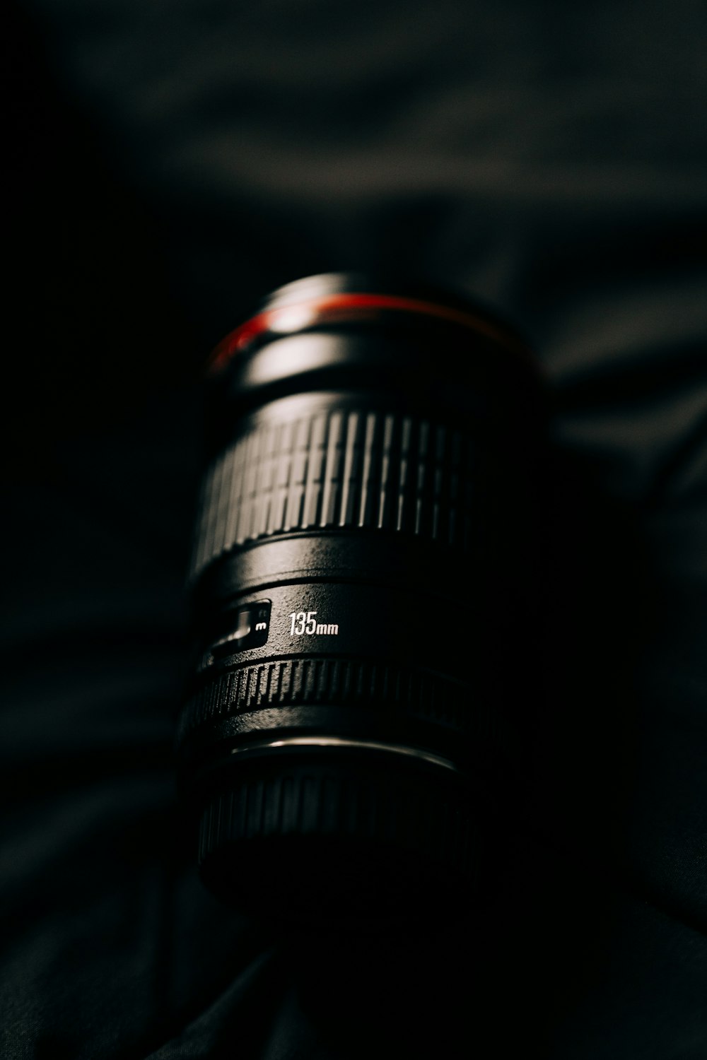 a close up of a camera lens on a bed