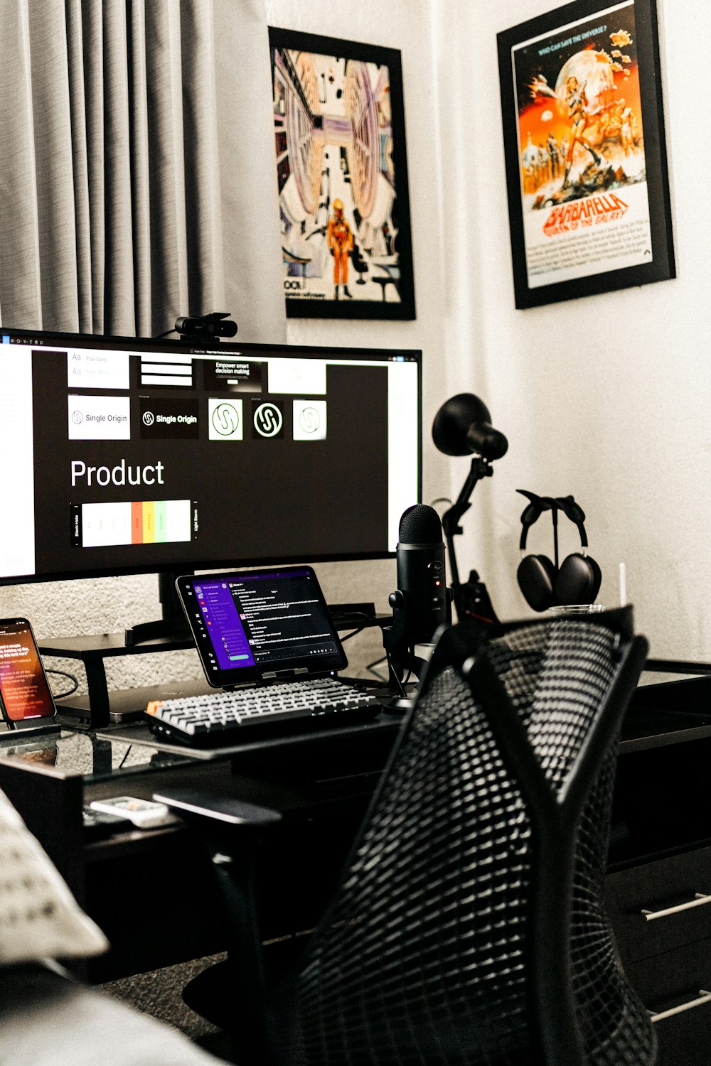 a desk with a computer and a laptop on it