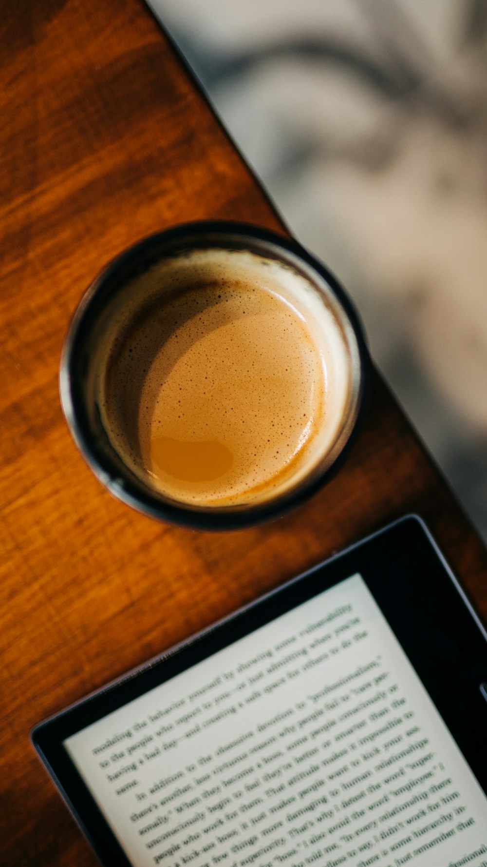 a tablet and a cup of coffee on a table