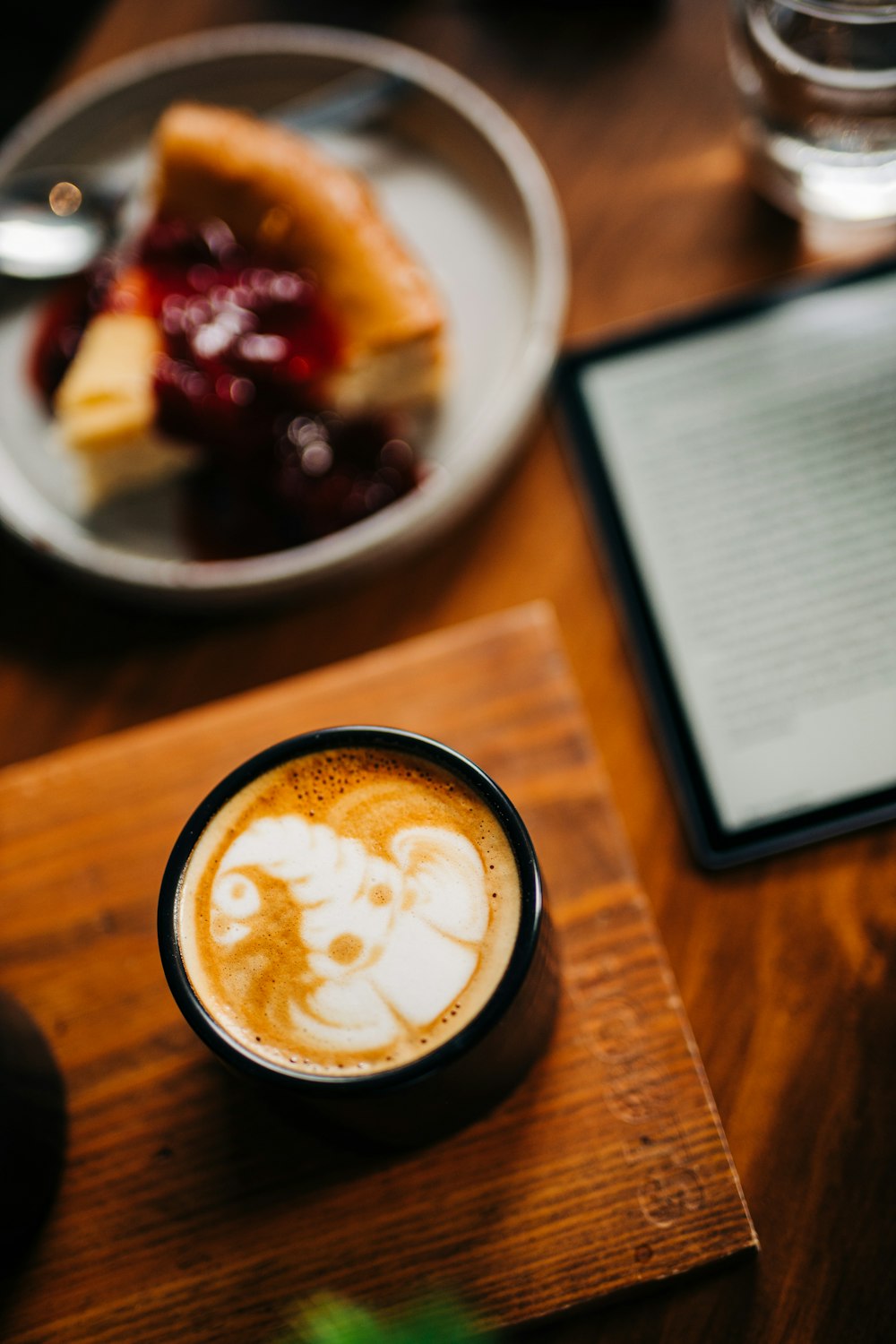 a cup of cappuccino on a wooden table