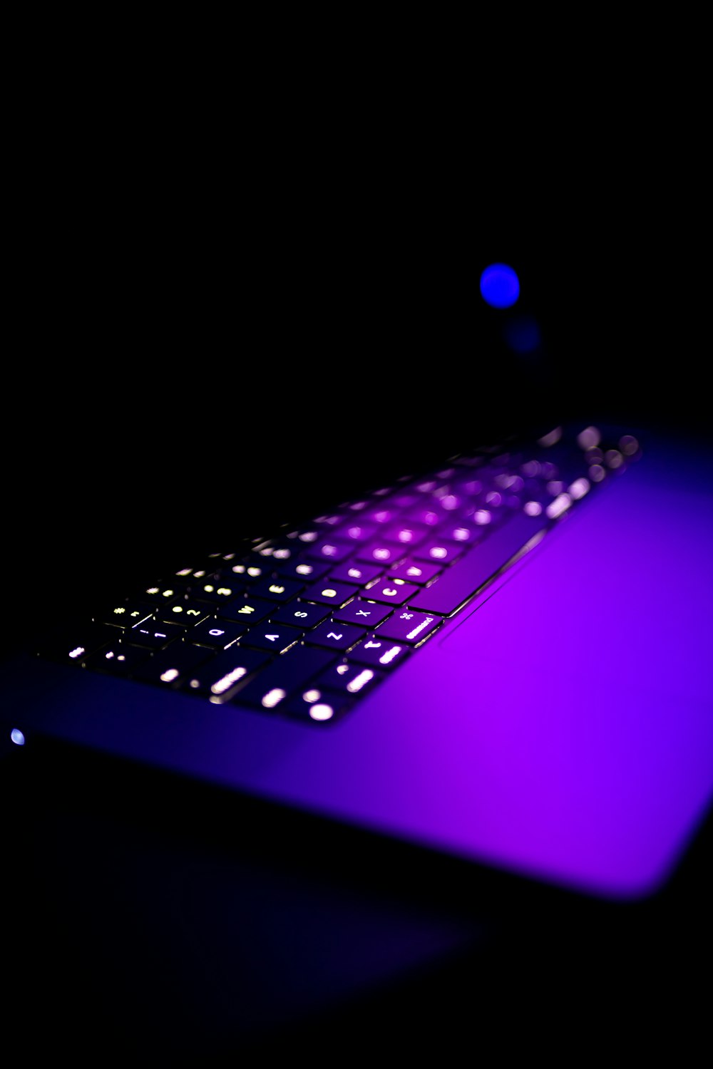 a computer keyboard lit up in the dark