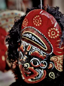 Close-up of intricate hand-painted details on a festival mask.