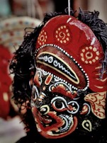 A close-up of a colorful traditional Sri Lankan mask displayed at a local cultural festival.
