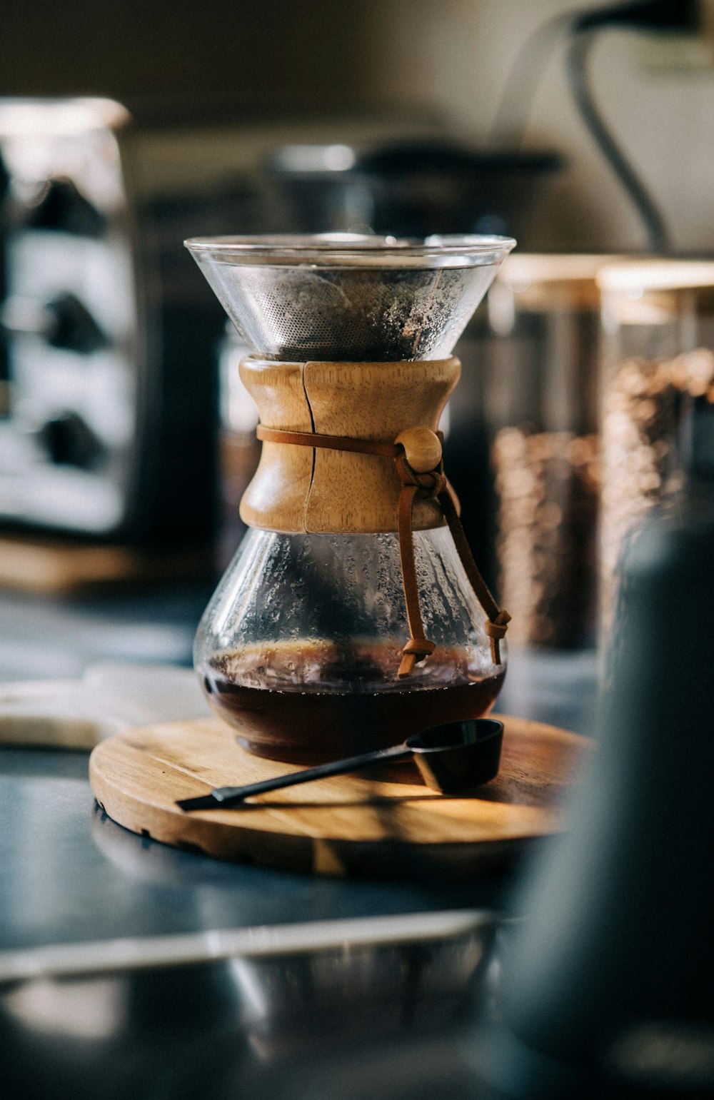 a coffee pot sitting on top of a wooden cutting board