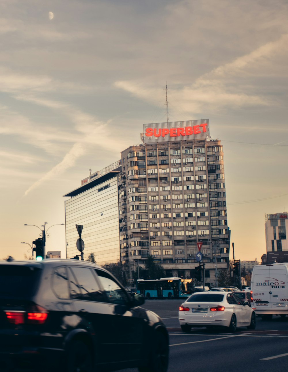 a busy city street with a tall building in the background