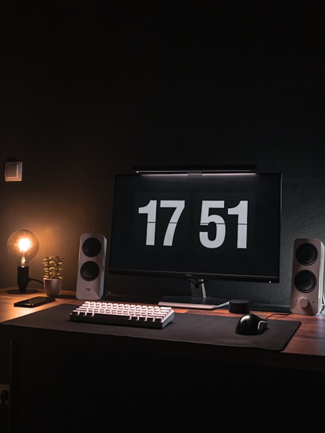a computer monitor sitting on top of a wooden desk