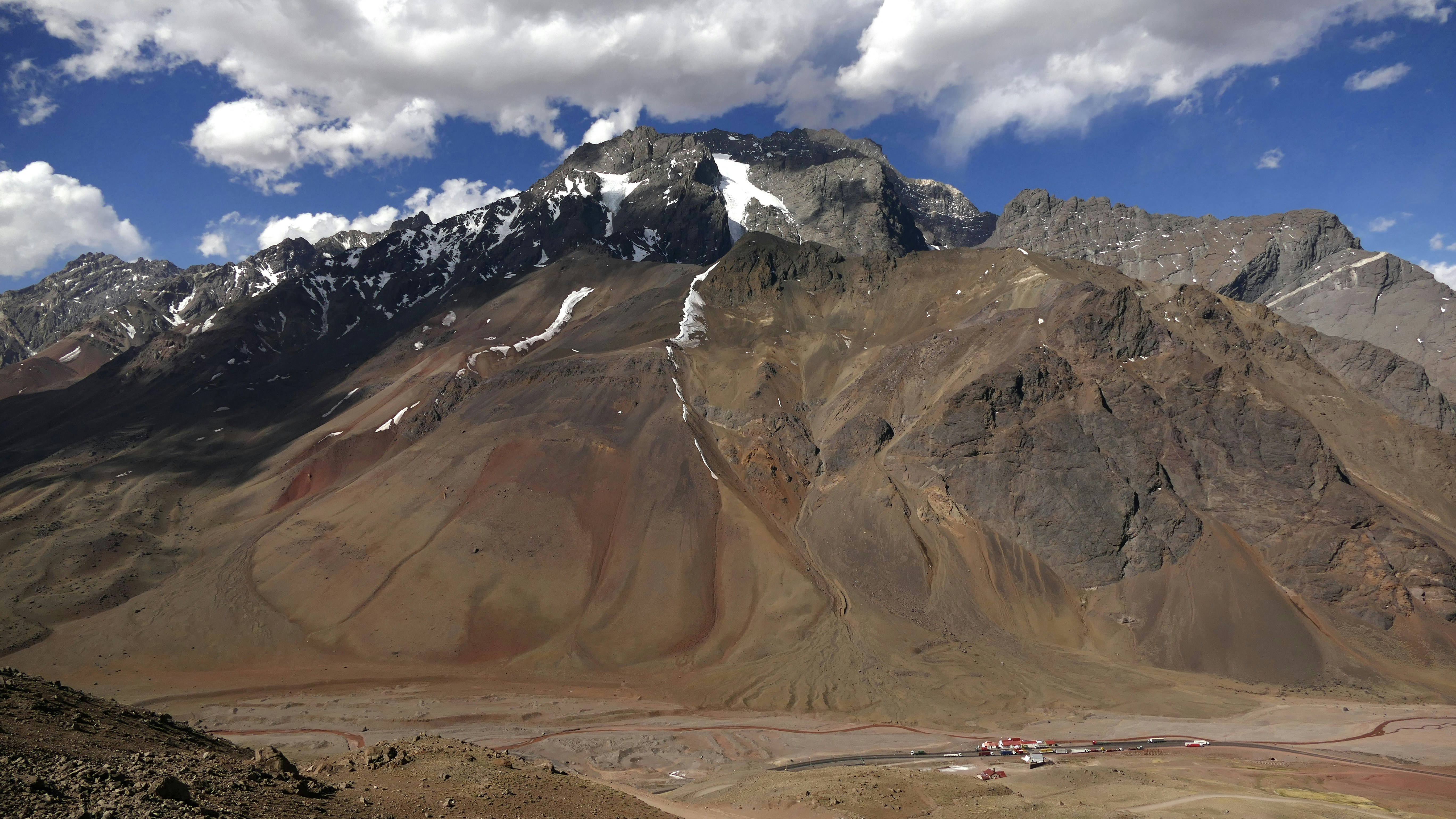 a view of a mountain range with clouds in the sky
