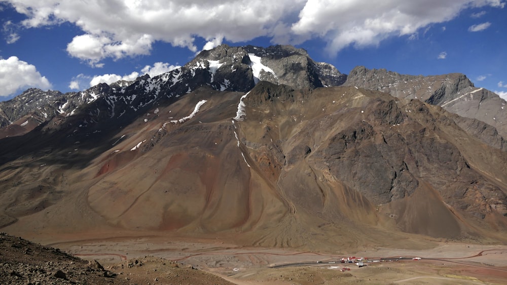 a view of a mountain range with clouds in the sky