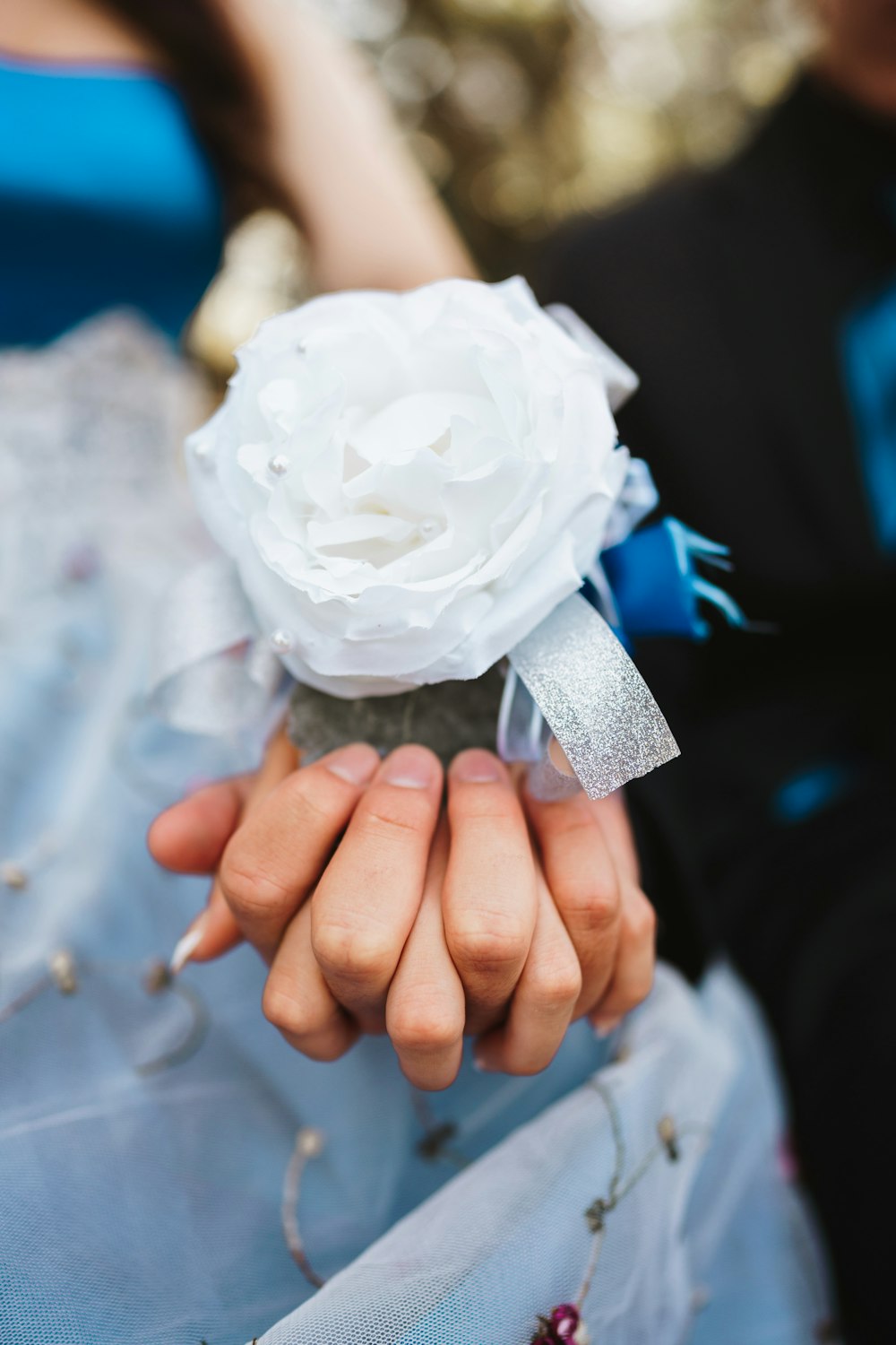 a close up of a person holding a flower