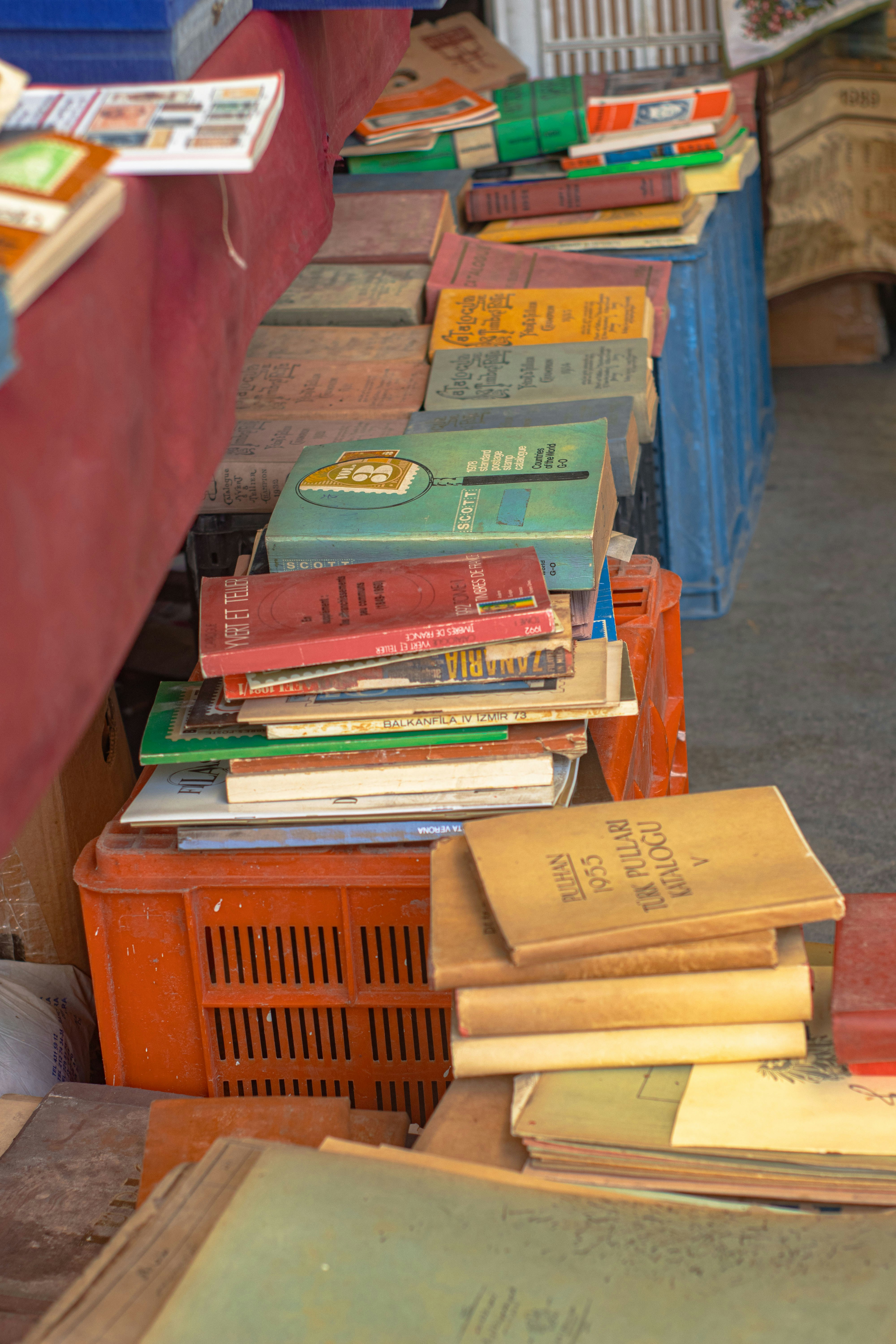 a pile of books sitting on top of a wooden table