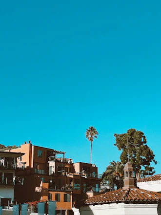 A modern Nigerian residential neighborhood showcasing eco-friendly homes under a bright sky.