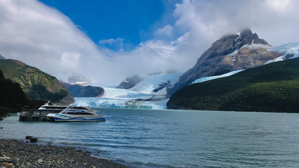 a boat in a body of water near a glacier