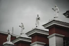 a group of statues on top of a building