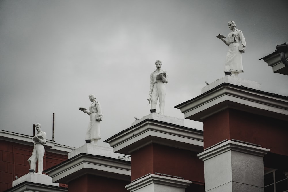 a group of statues on top of a building