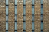 a large brick building with a clock on it's side