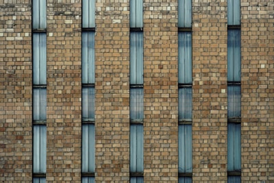 a large brick building with a clock on it's side