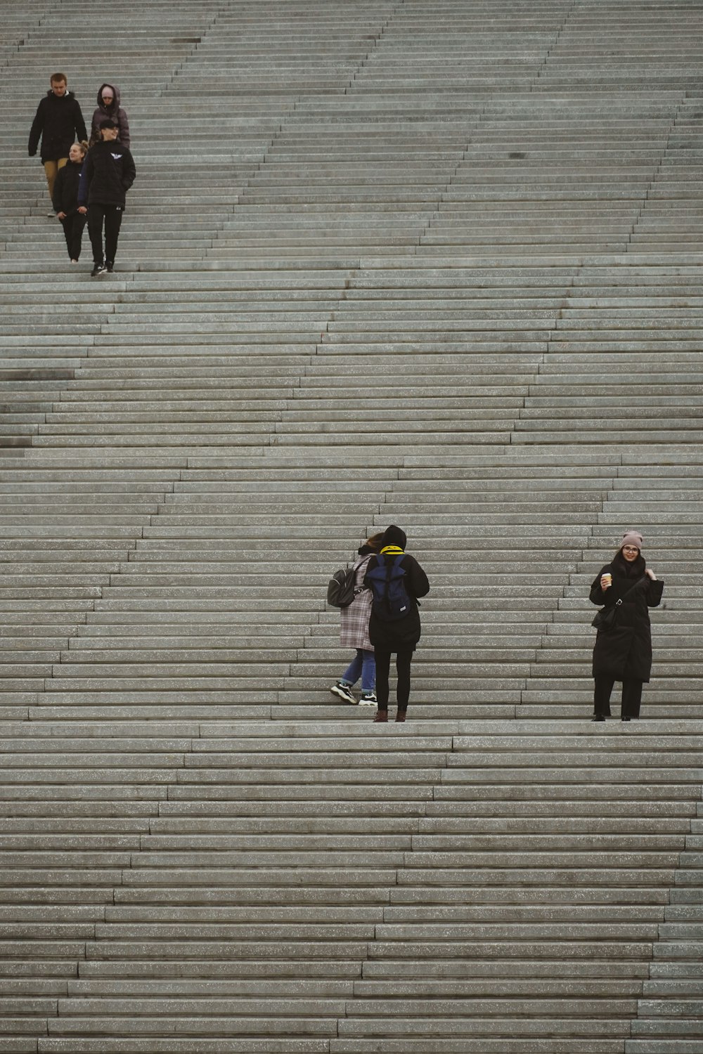 a group of people walking up steps in a stadium