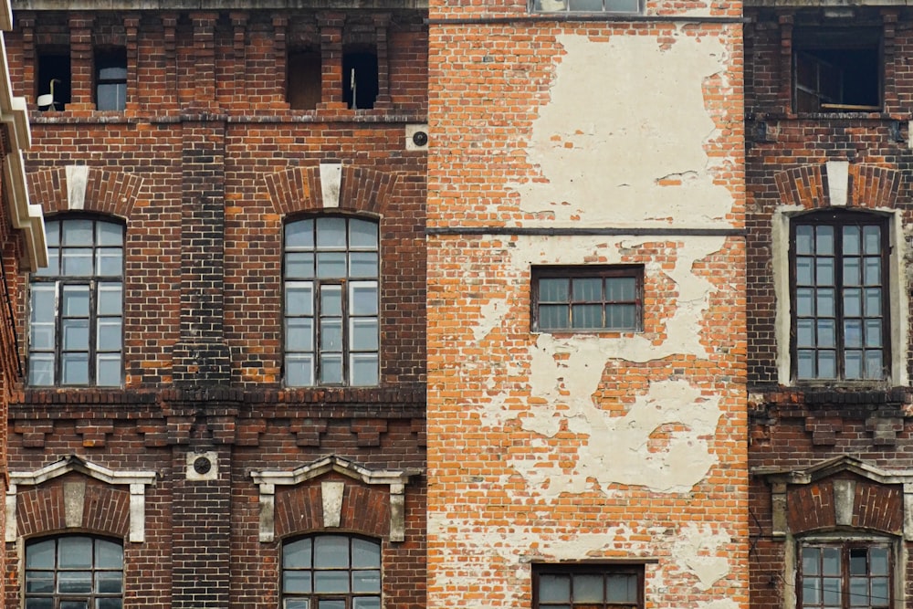 an old brick building with windows and a clock