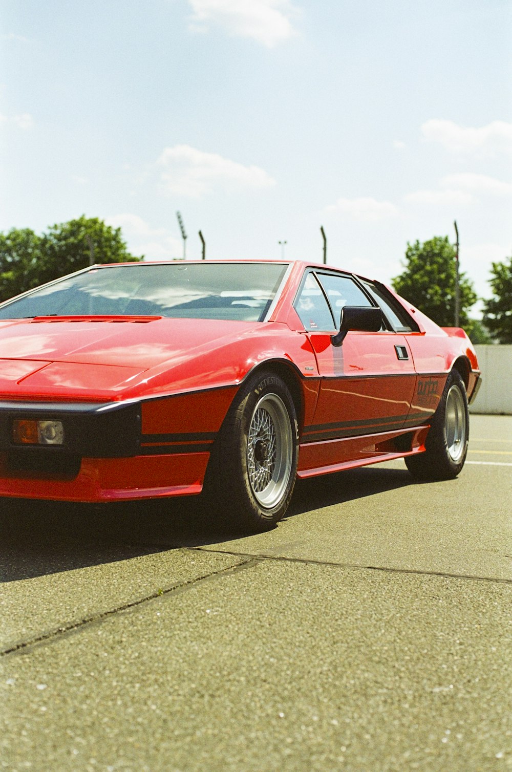 a red sports car parked in a parking lot