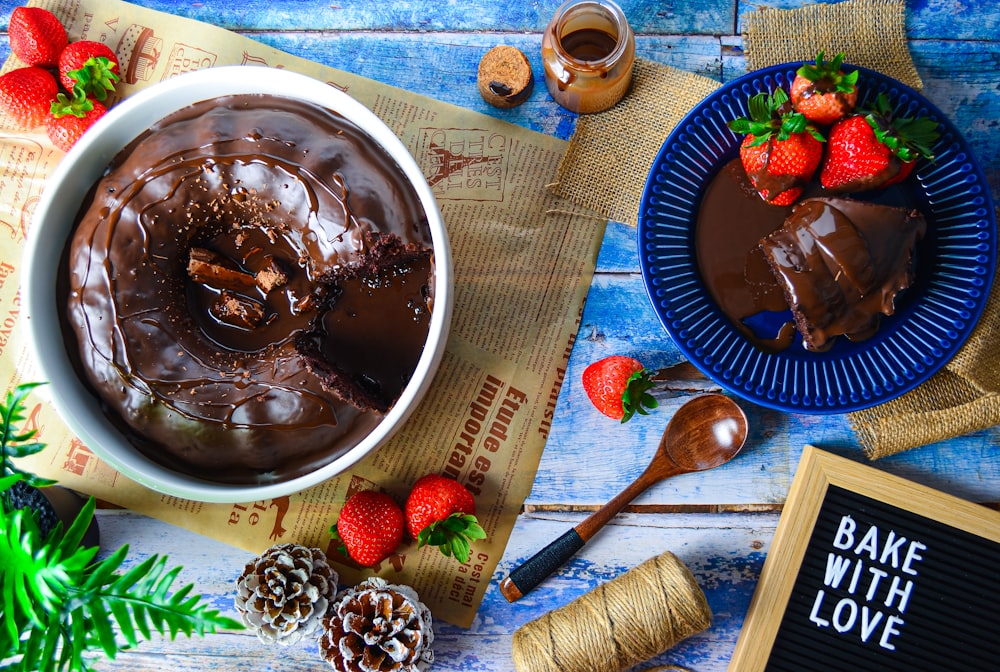 a table topped with a bowl of chocolate cake