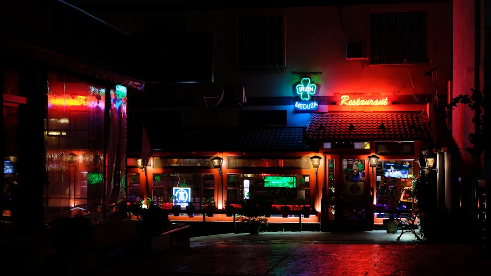 a building with a neon sign lit up at night