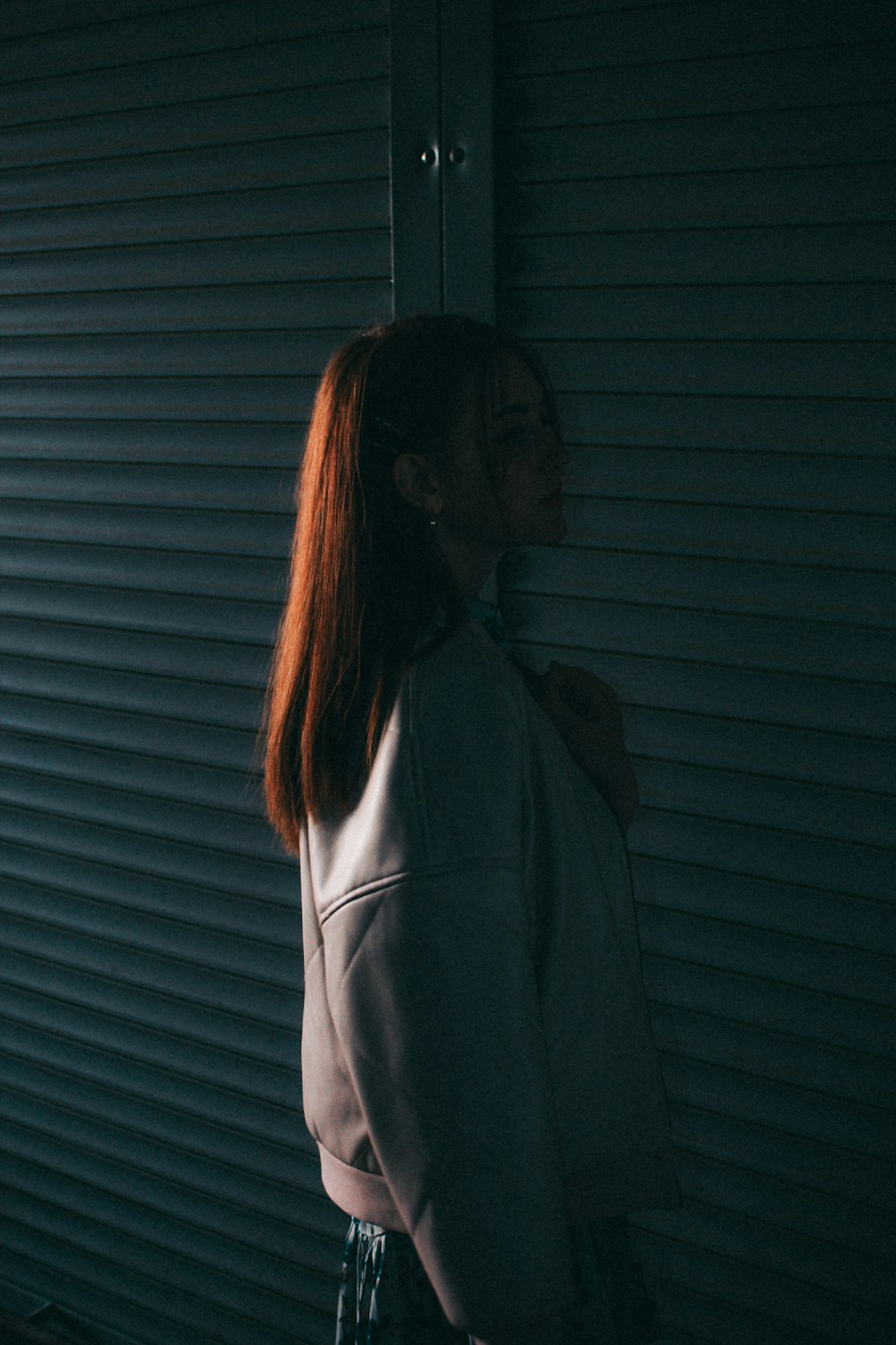 a woman standing in front of a garage door