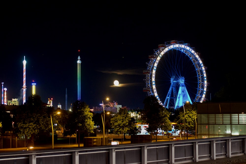 a ferris wheel lit up in the night sky