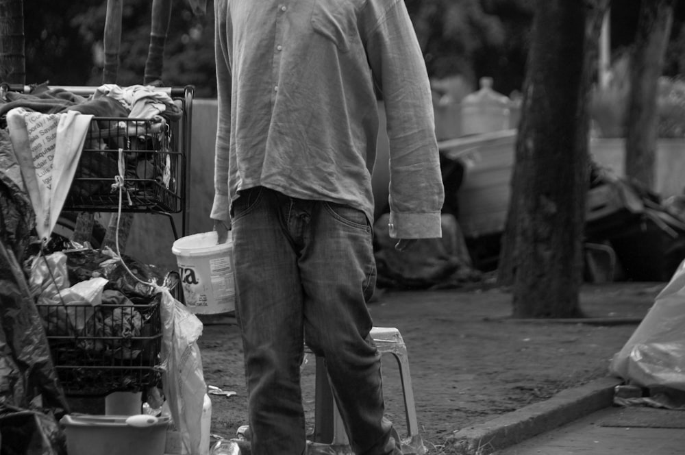 a man standing next to a pile of garbage