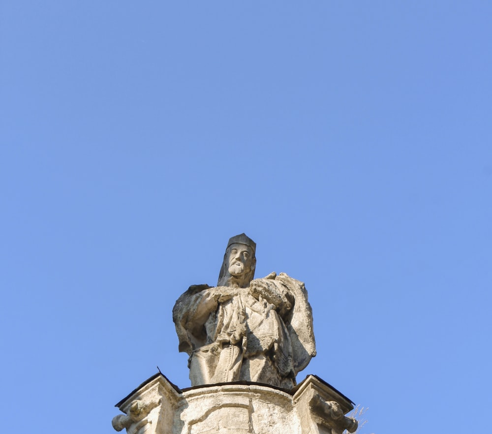 a statue of a man on top of a building