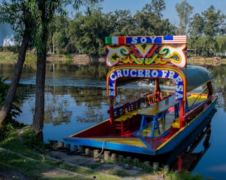a colorful boat floating on top of a body of water
