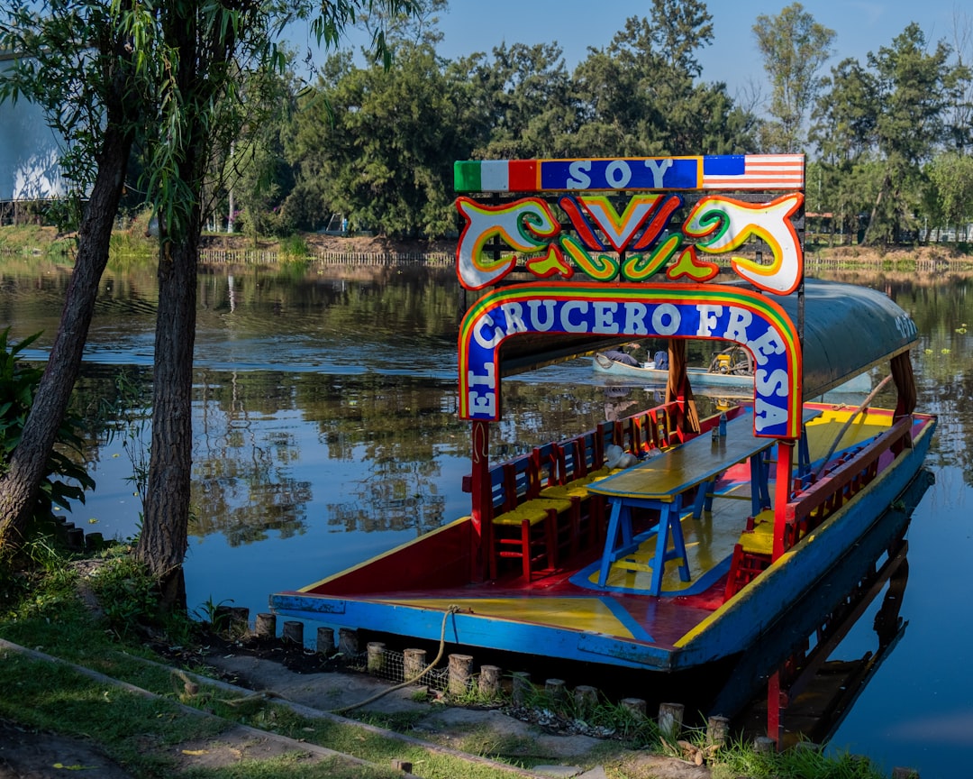 a colorful boat floating on top of a body of water,